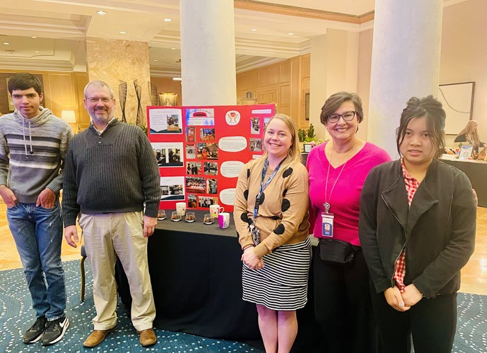 students and staff presenting at a conference